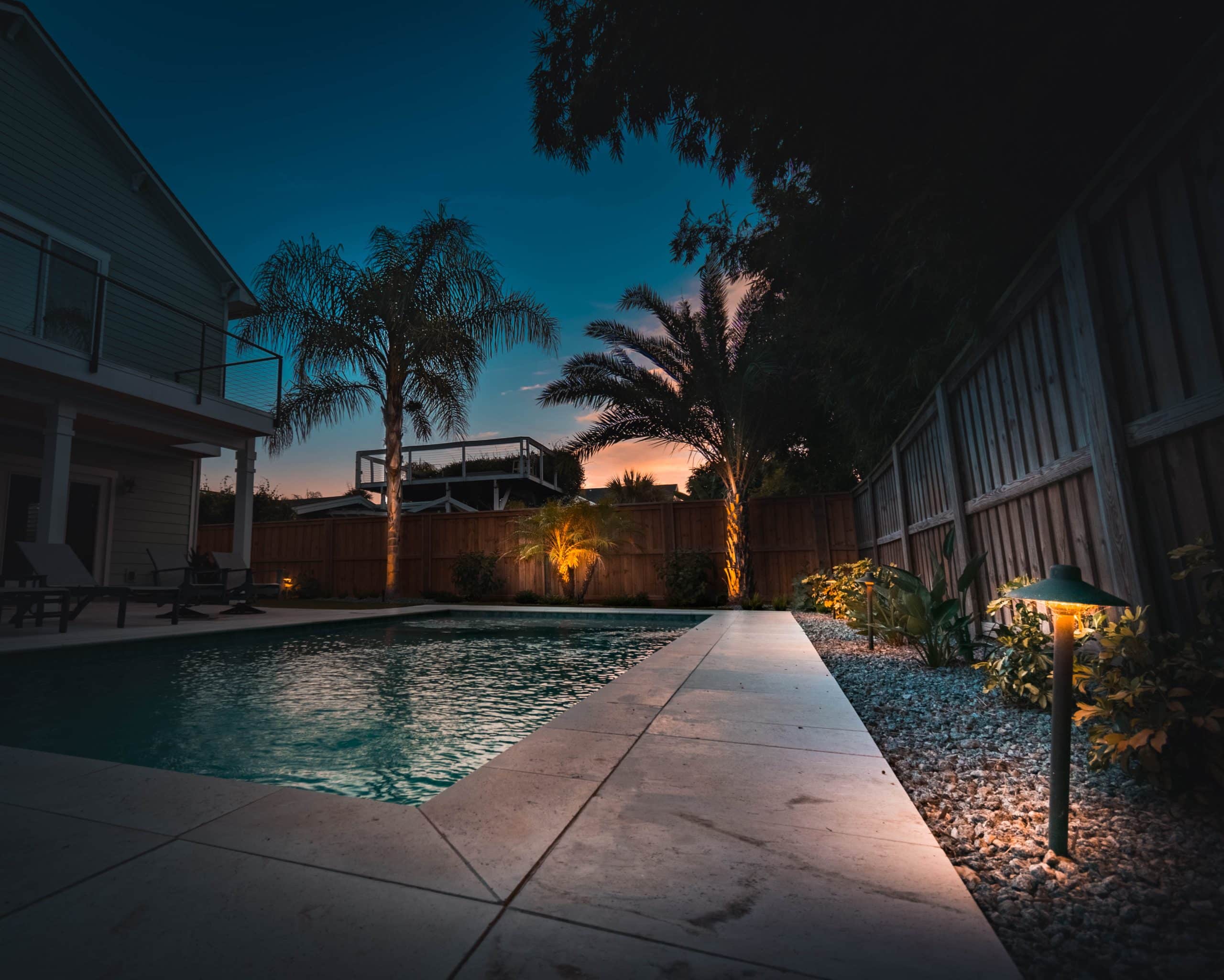 New Construction Landscaping Lighting - thermal pool deck pavers night view